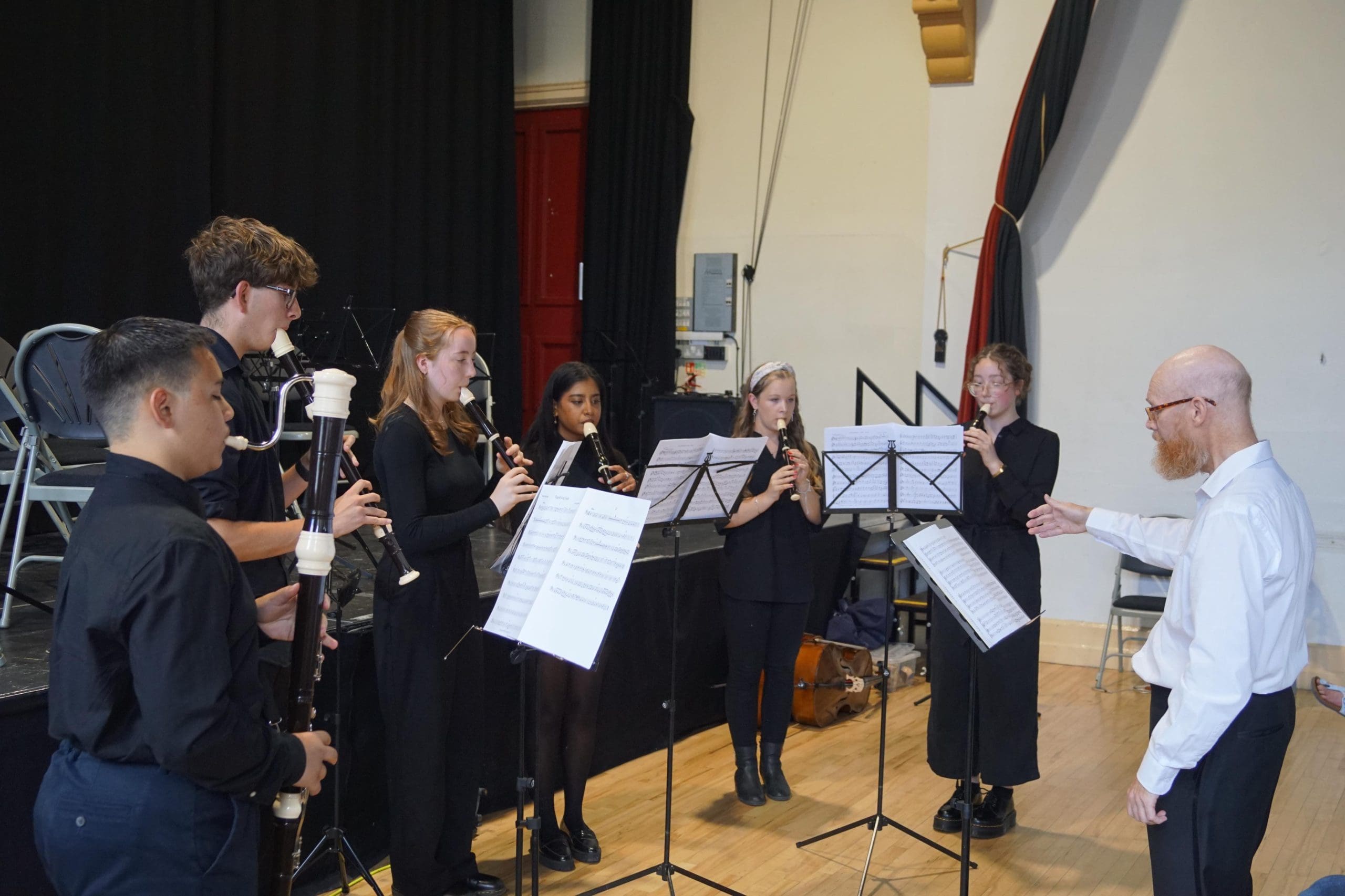 A group of music students playing various recorders