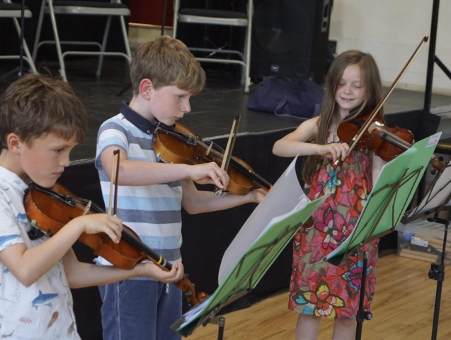 three young violin players
